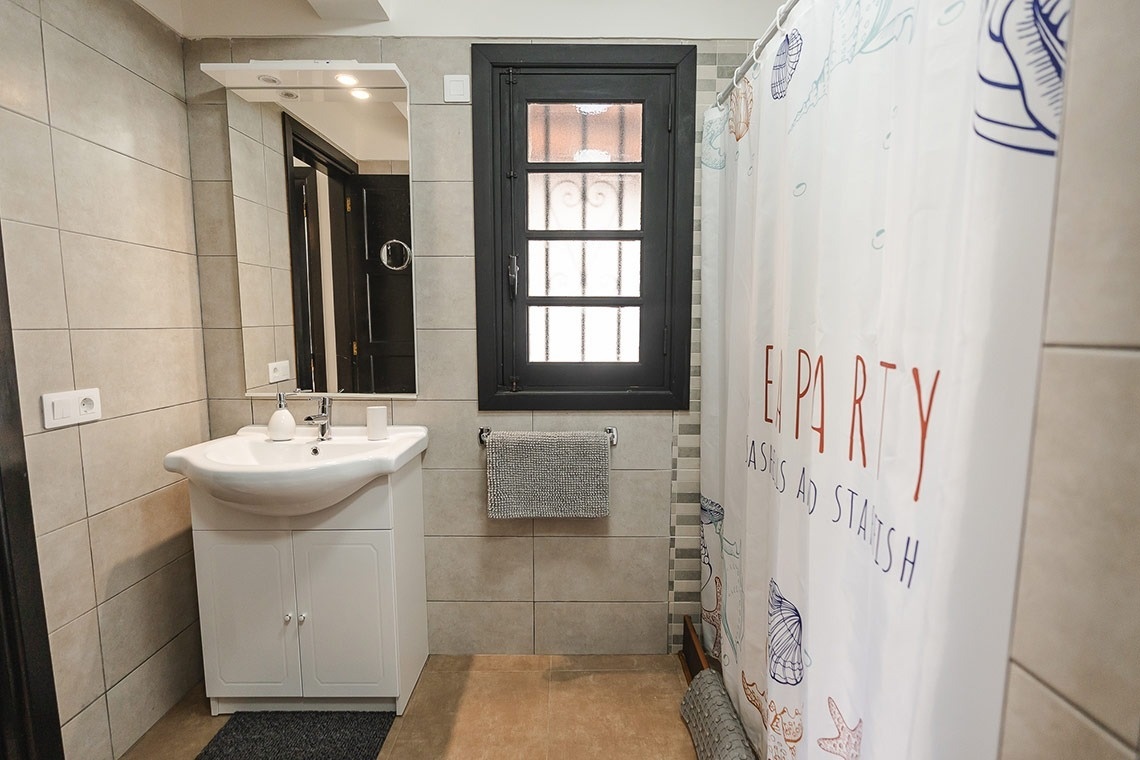 a bathroom with a shower curtain that says party