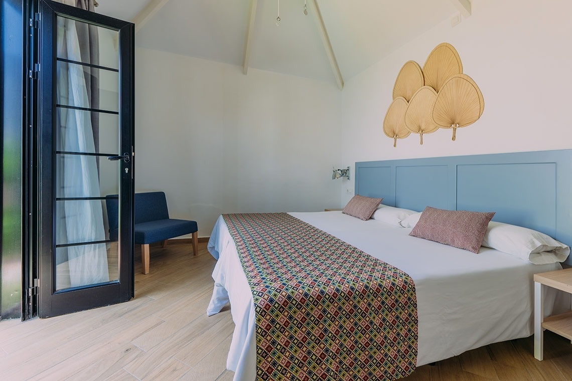 a bedroom with a king size bed and a chair