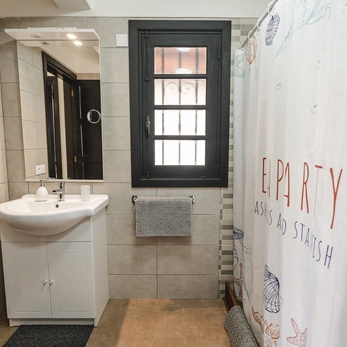 a bathroom with a shower curtain that says party