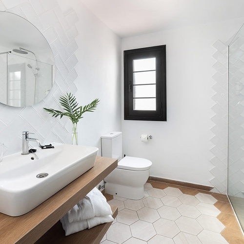 a bathroom with a toilet a sink and a shower