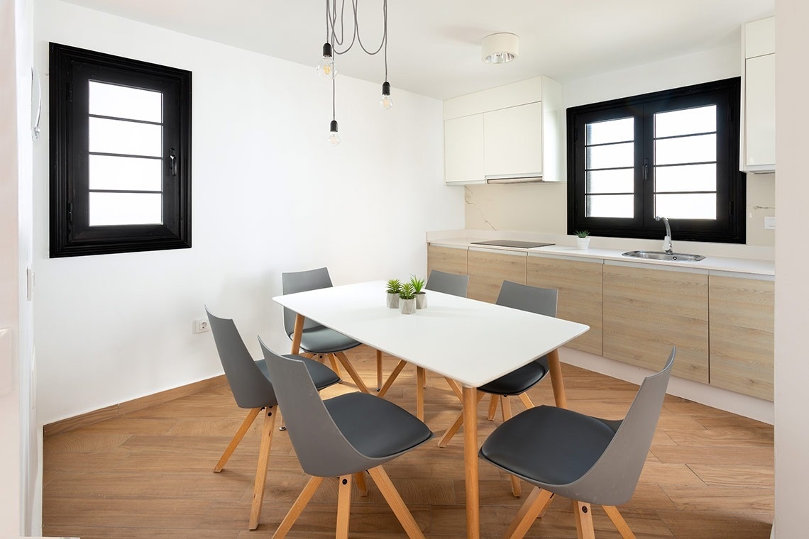 a kitchen with a table and chairs and a sink