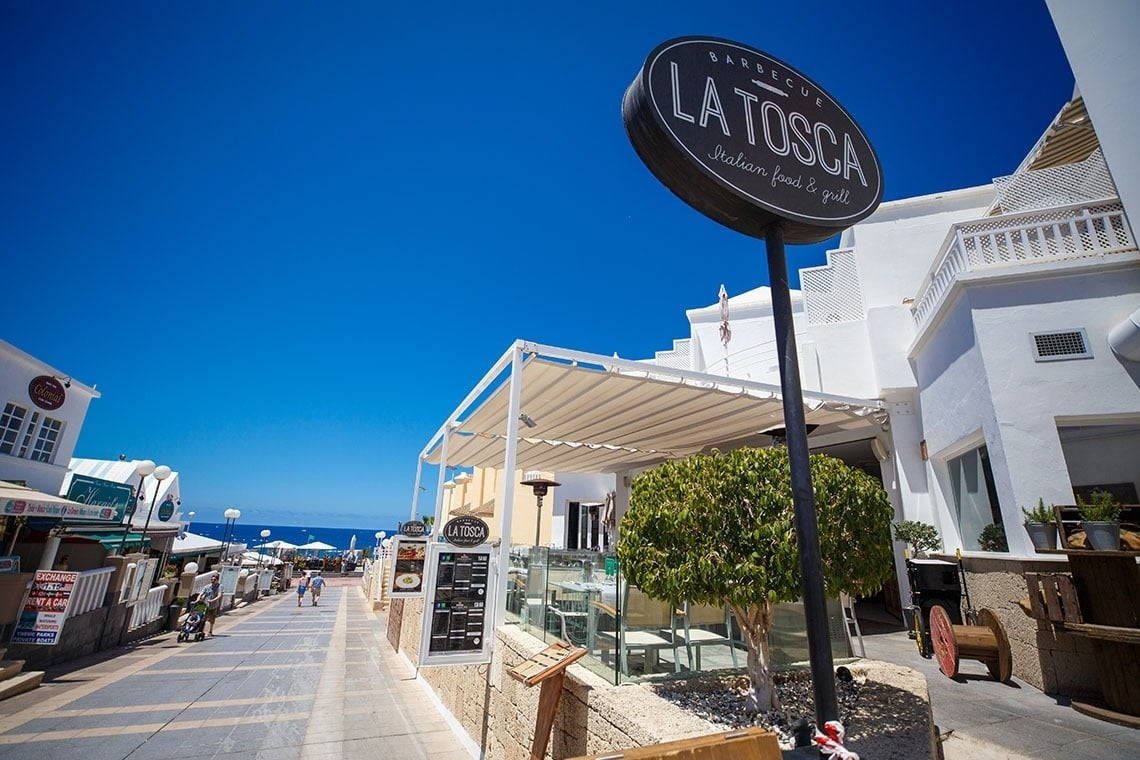 a sign for la tosca barbecue italian food & grill