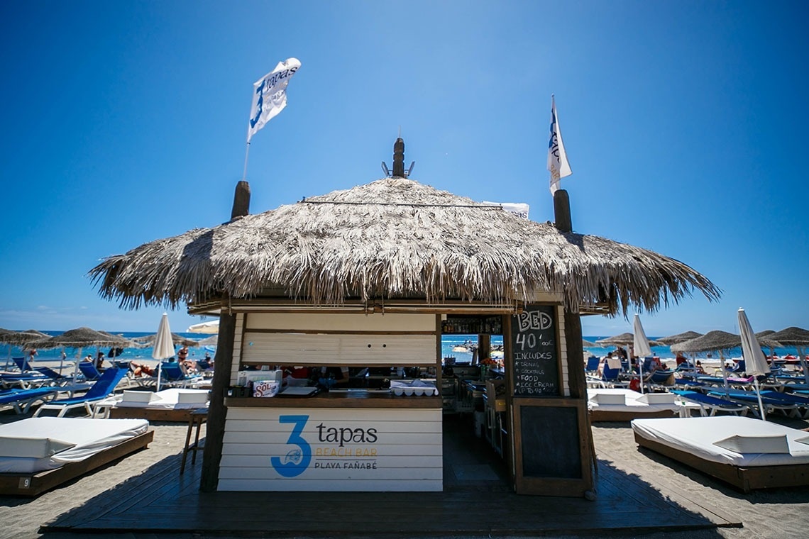 a thatched hut with a sign that says 3 tapas