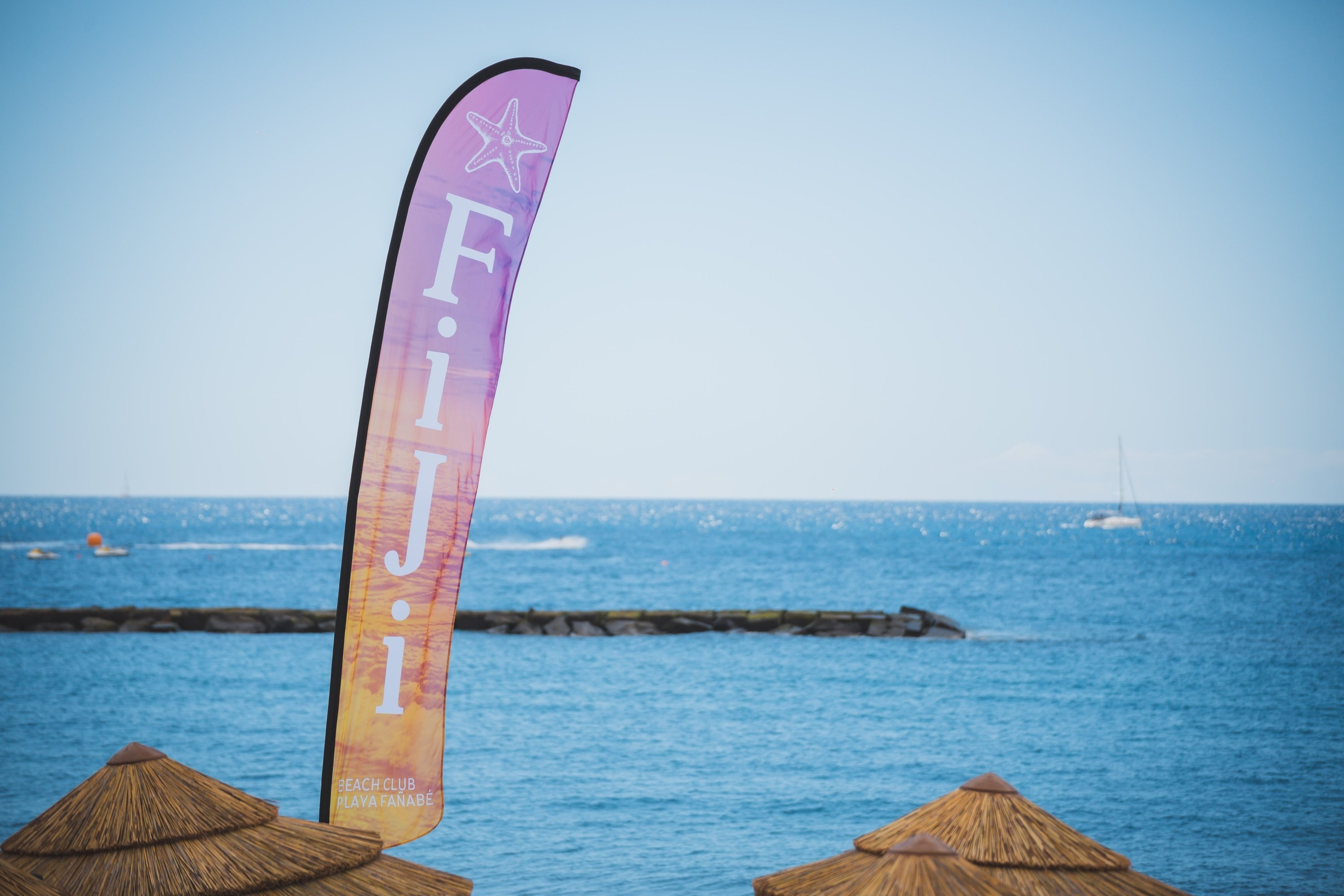 a purple and orange flag that says fiji on it