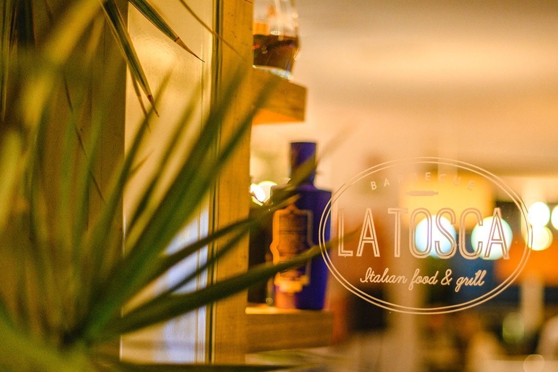 a sign for la tosca italian food and grill