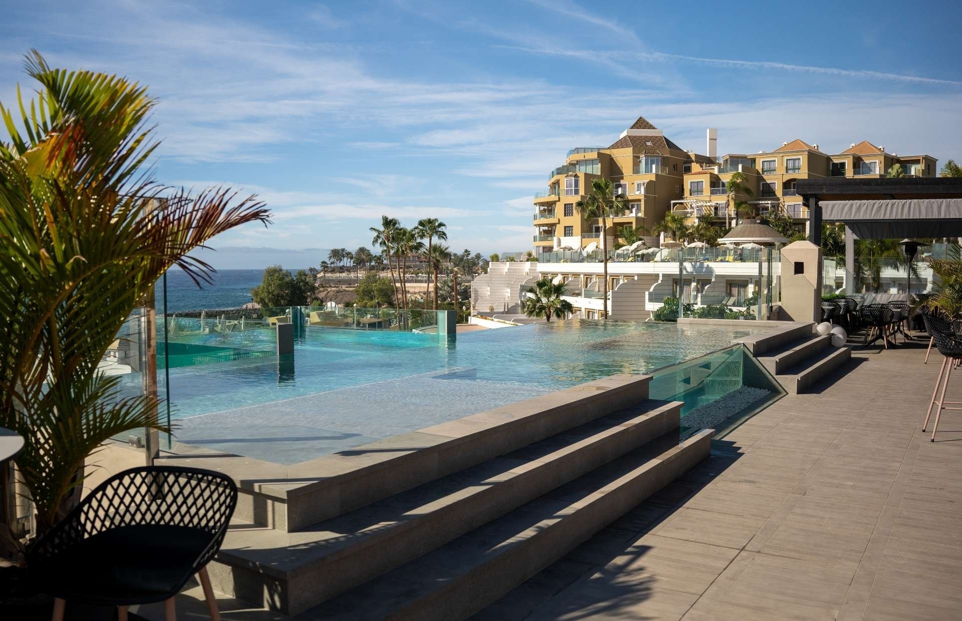 a swimming pool with a large building in the background