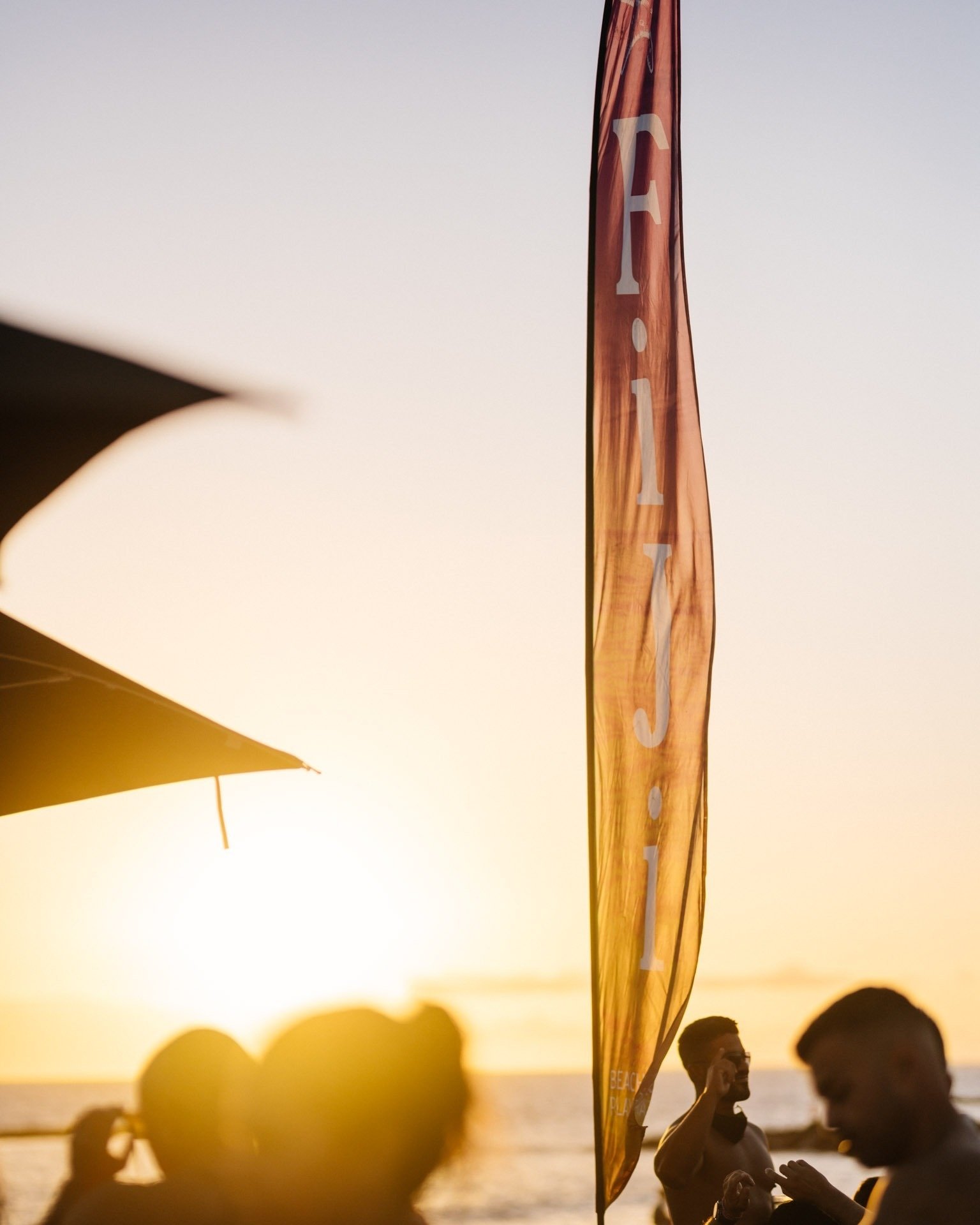 a man stands in front of a flag that says fiji