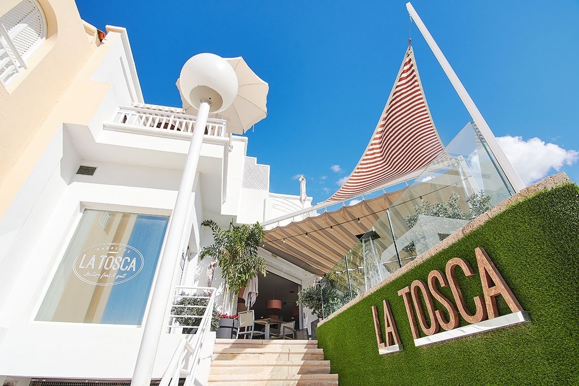 a white building with a sign that says la tosca