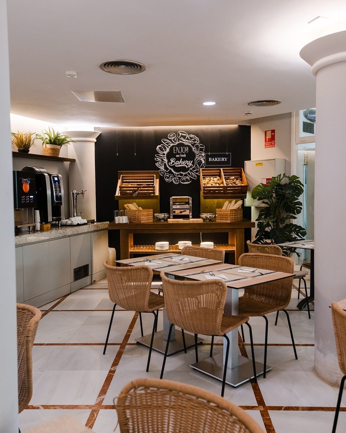 a restaurant with tables and chairs and a sign that says bakery