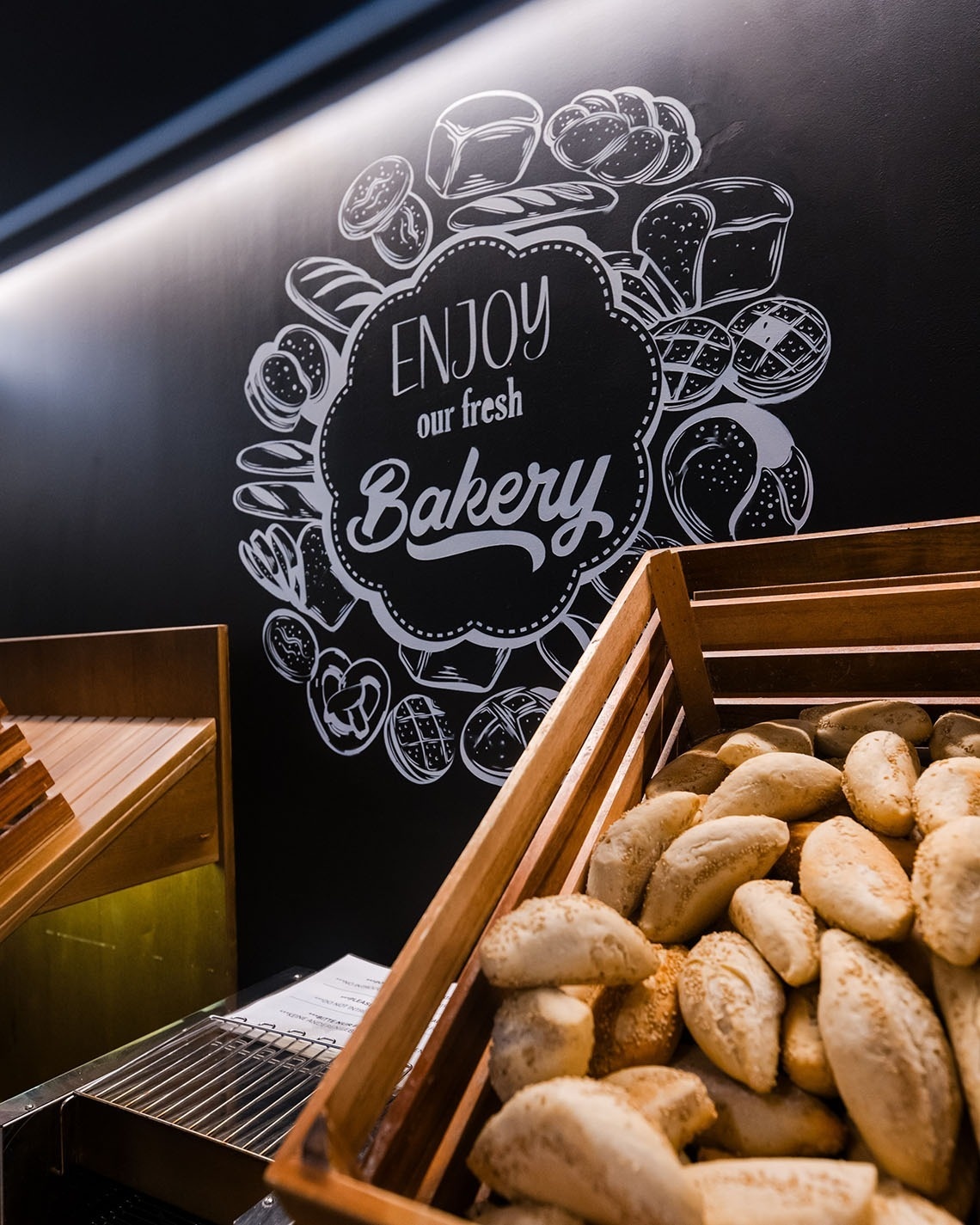 a sign on a wall that says enjoy our fresh bakery