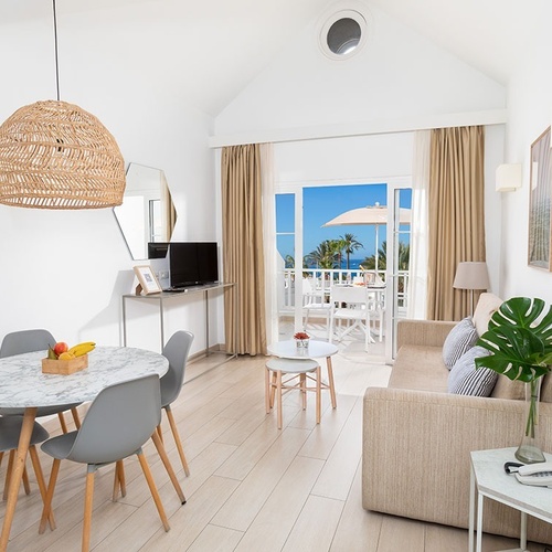 a living room with a couch a table and chairs