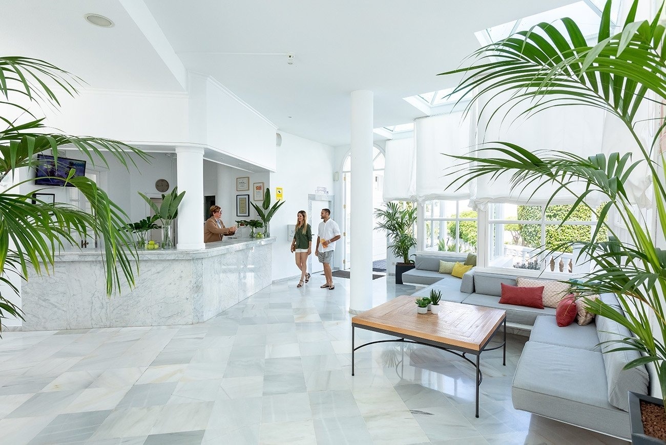 a large swimming pool in front of a building that says reception