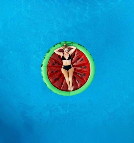 a restaurant with a chef preparing food in the background