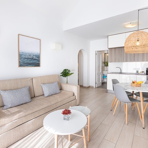 a living room with a couch a table and chairs