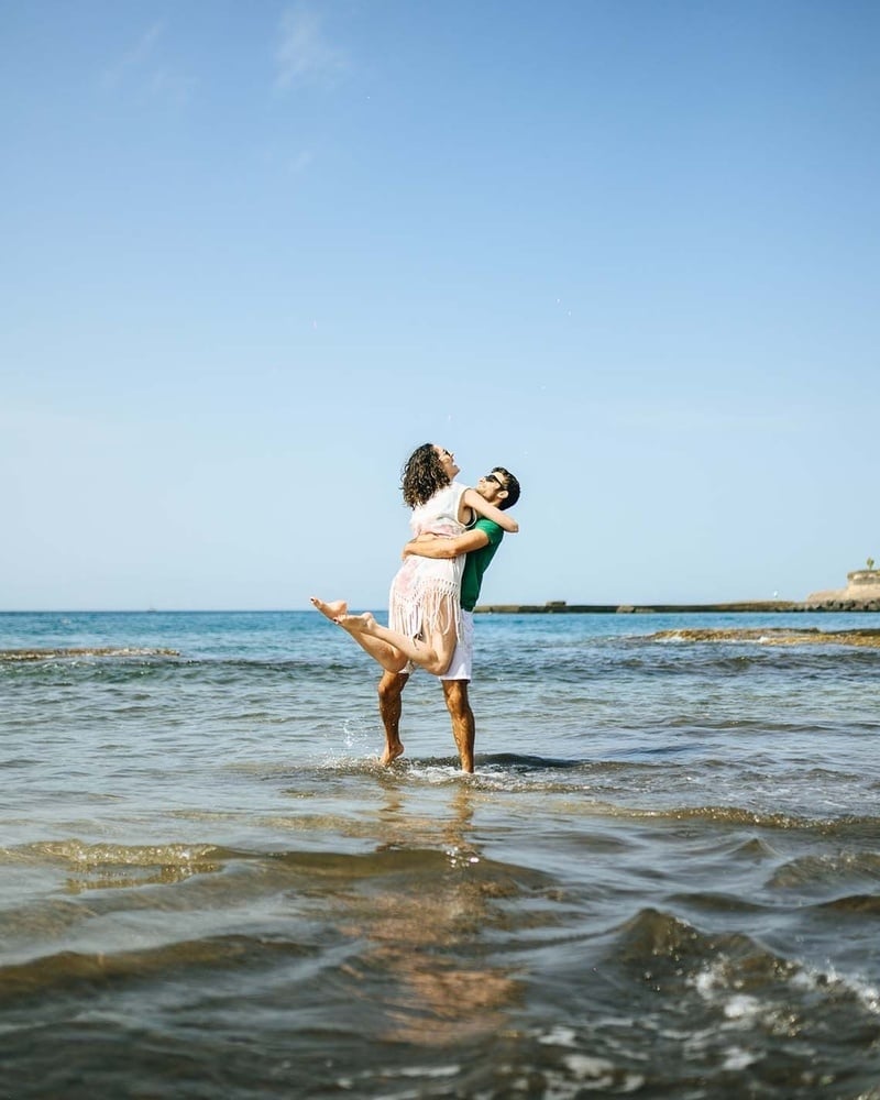 a patio with tables and chairs and umbrellas on a sunny day