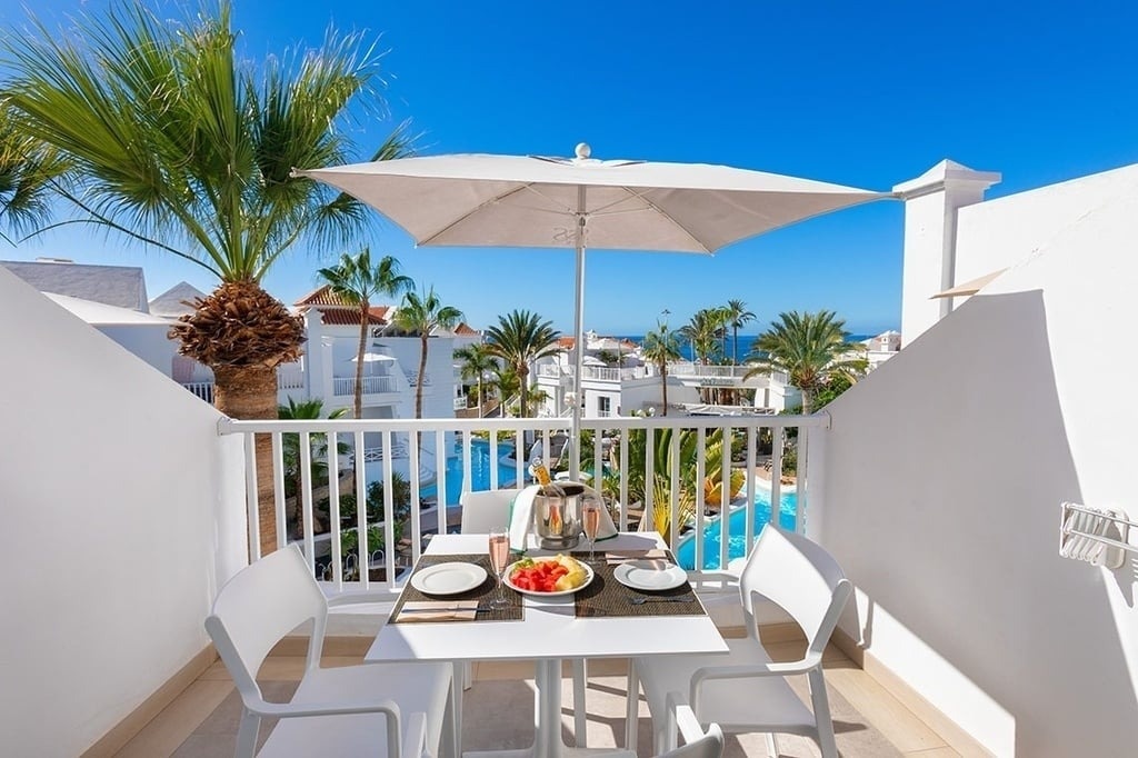 a hamburger and a glass of beer on a table