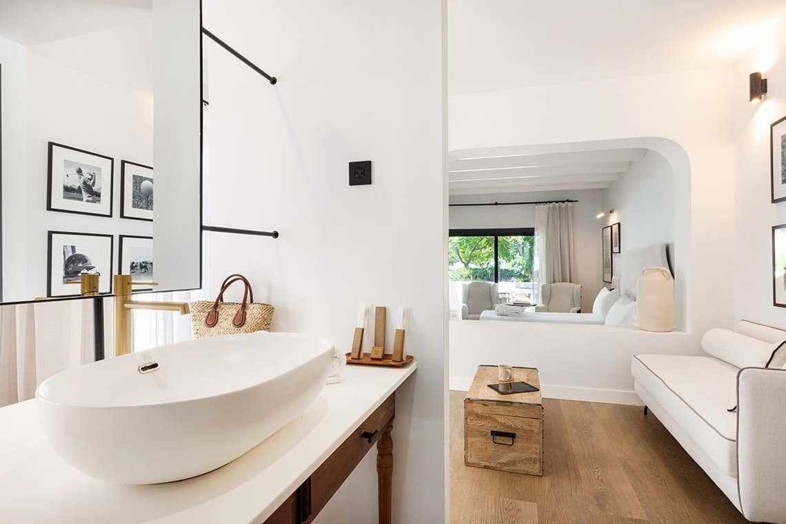 un baño con un lavabo y un sofá blanco