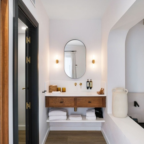 a bathroom with a sink and a mirror with the letter a on it