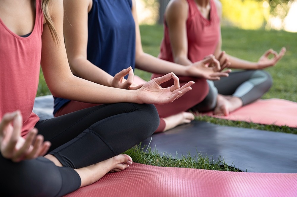 
                                    a group of women are practicing yoga on rocks near the ocean