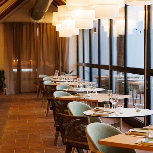 a restaurant with tables and chairs and a large window