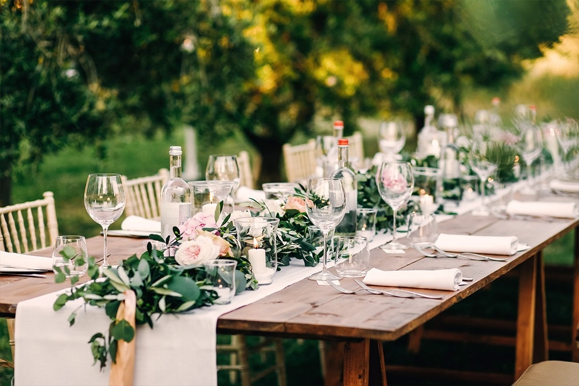 
                                    a table set with plates utensils and flowers on it