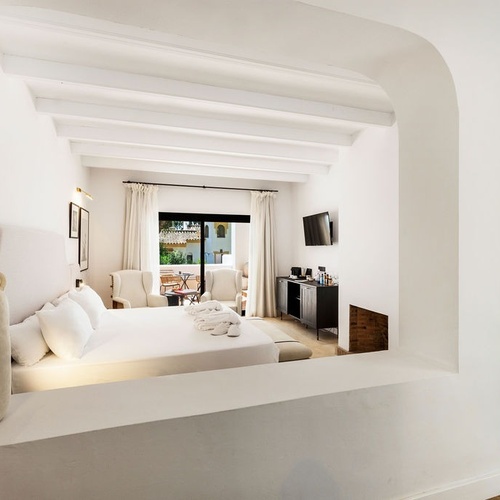 a bedroom with a large bed and a television