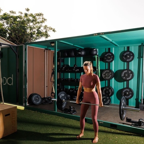 a woman is lifting a barbell in a gym that says in mood