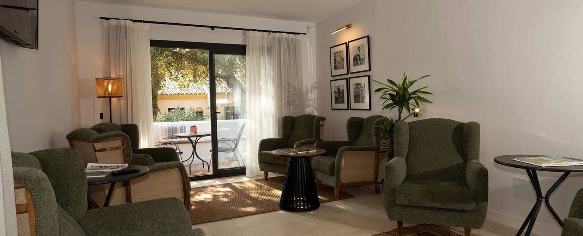 a living room with green chairs and a table