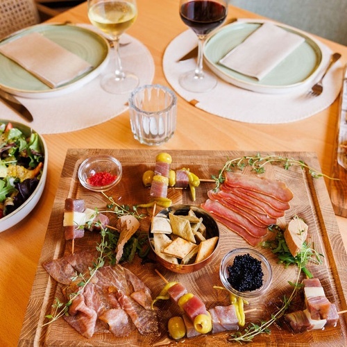 a wooden cutting board with a variety of food on it