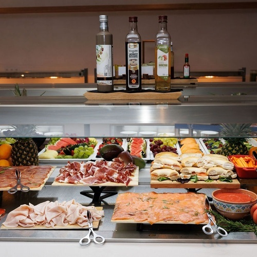 two bottles of arbea olive oil sit on a counter