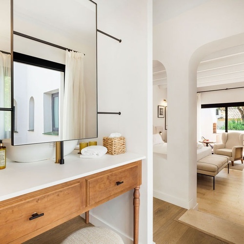 a bathroom with a wooden vanity and a sink