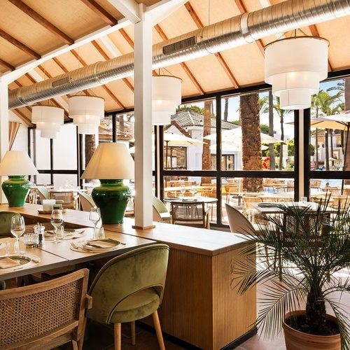 a restaurant with green lamps and green chairs