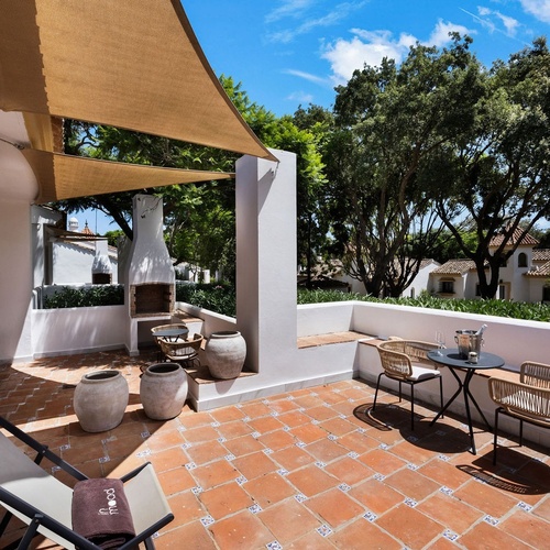 a patio with chairs and a table that says coral on it