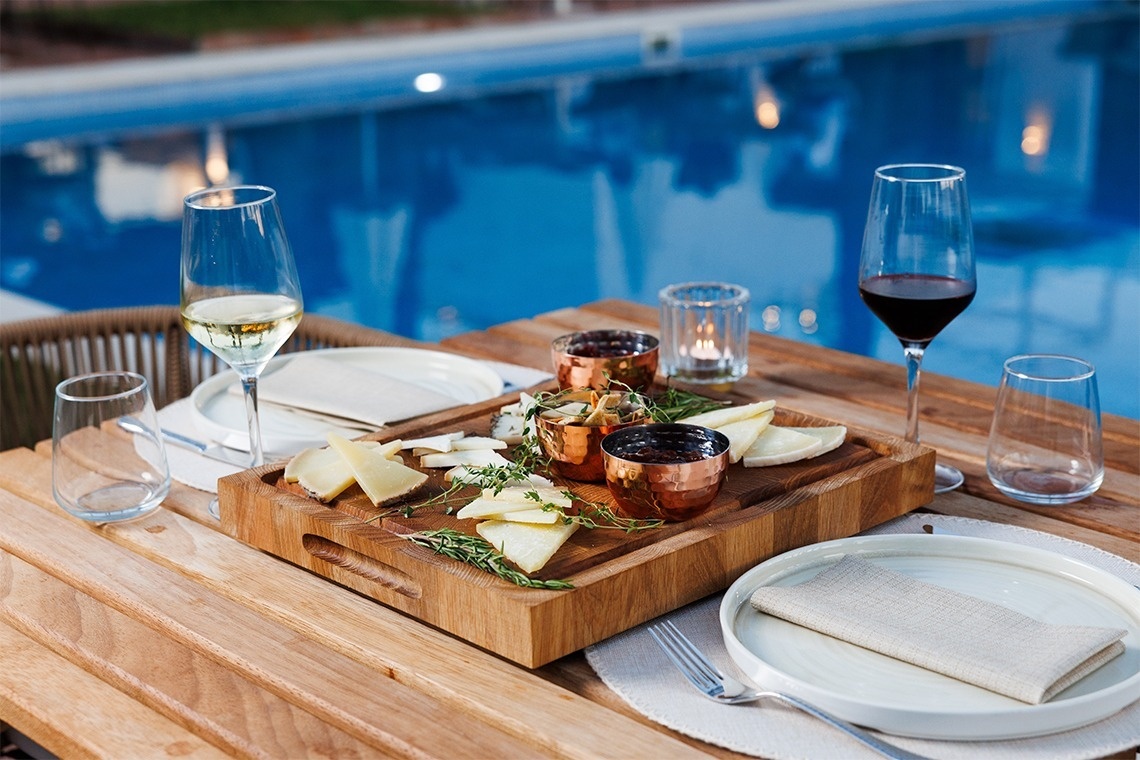 a woman sitting at a table with a plate of food and a cup of coffee