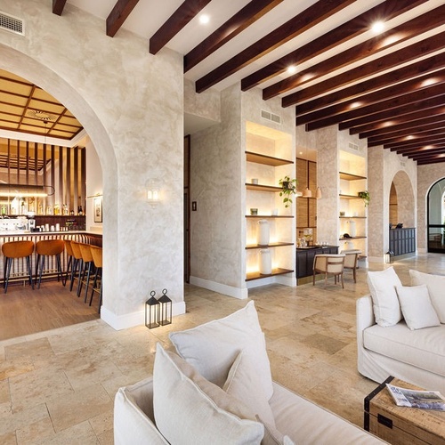 a living room with a couch and a bar in the background