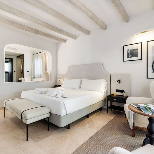 a bedroom with a large bed and two pictures on the wall