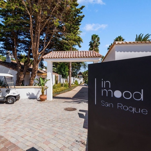 a golf cart is parked in front of a sign that says in mood san roque