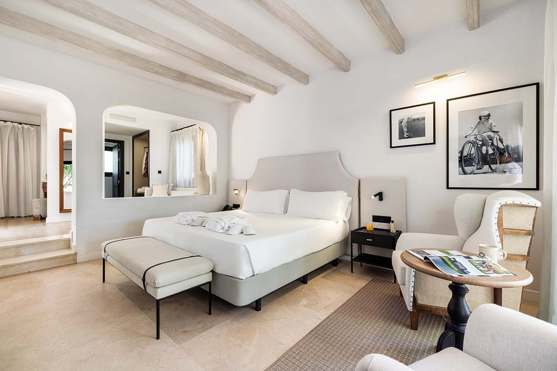 a bedroom with a king size bed and a chair