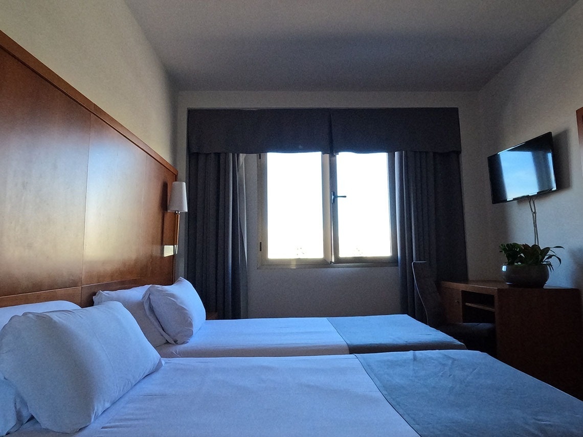 a bed with a tray of food and drinks on it