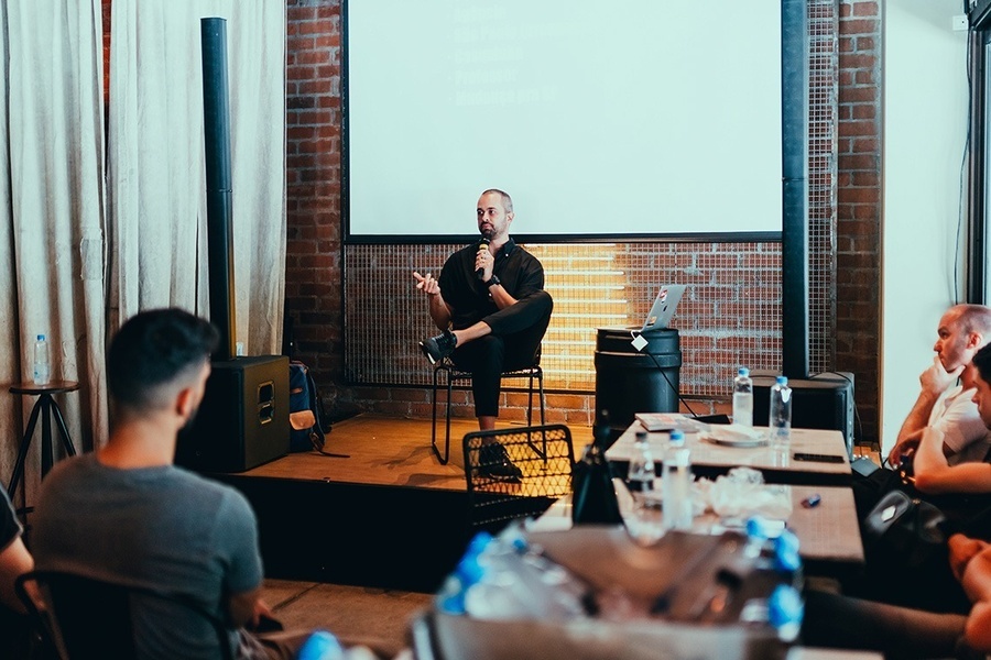 a man is giving a presentation in front of a projector screen