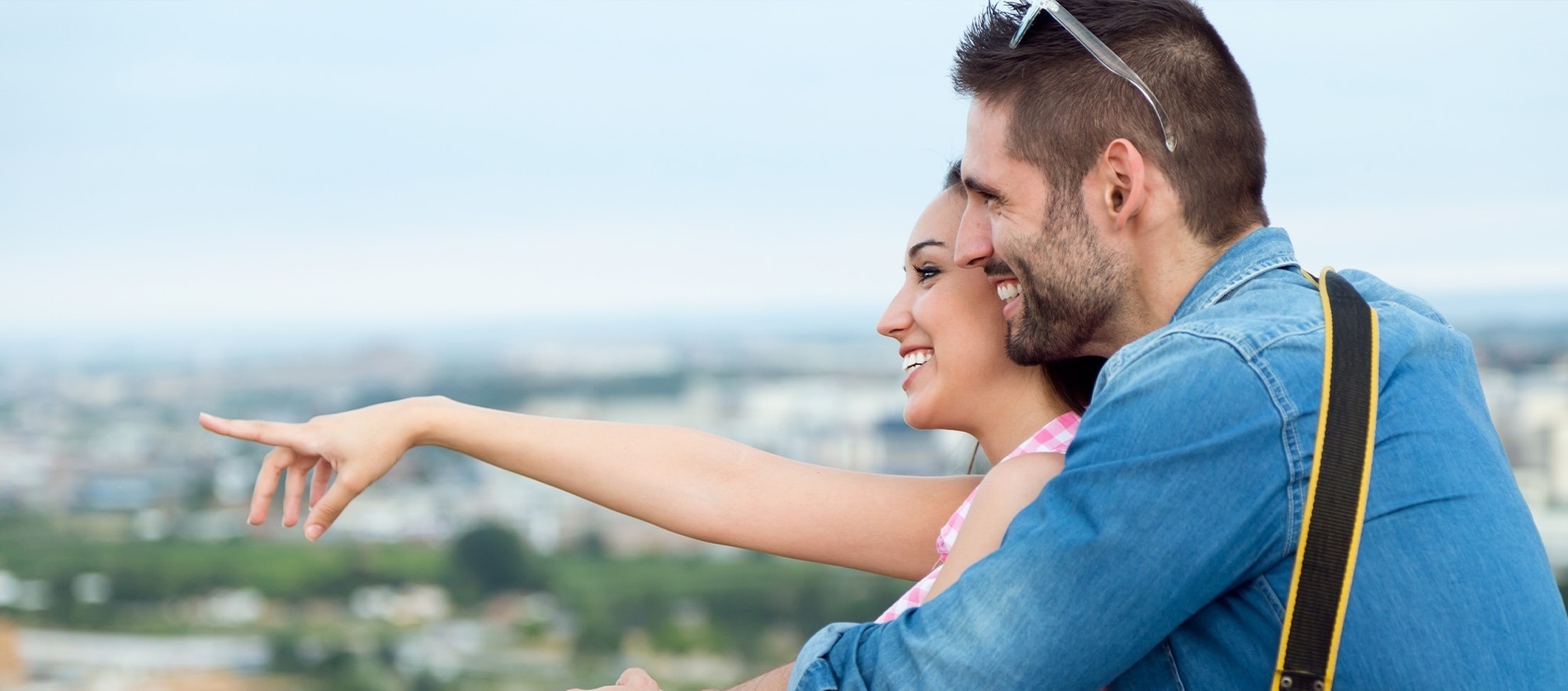 a man and a woman are looking out over a city