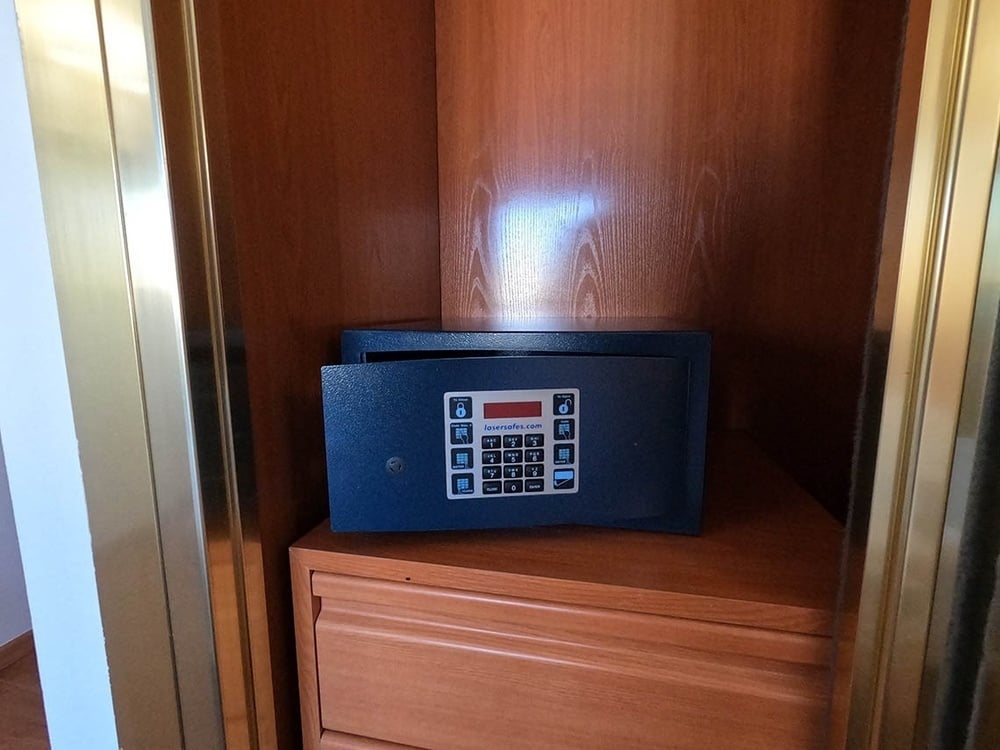 a safe in a closet with a digital keypad