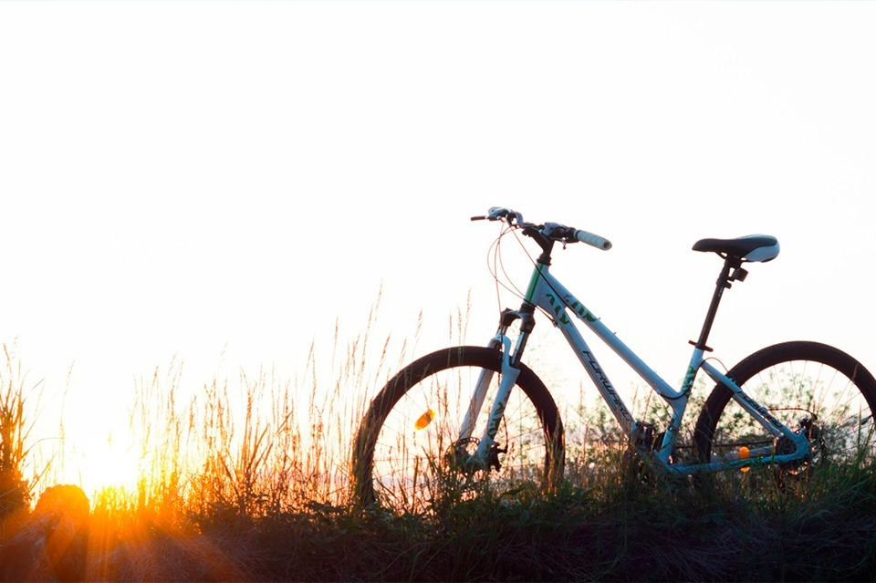Bicycle at sunset near Sea You: Port Saplaya, ocean view.