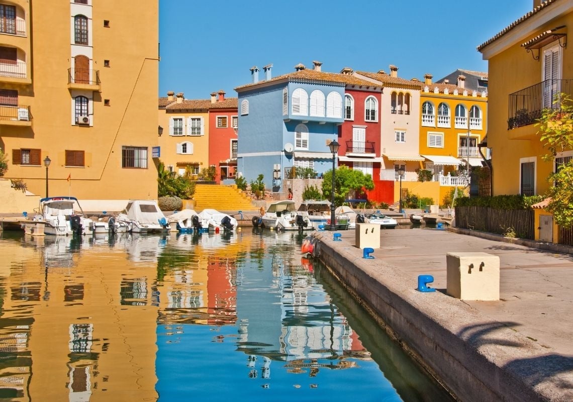 Port Saplaya: Apartamenti colorati sul porto, ideali per un soggiorno perfetto.
