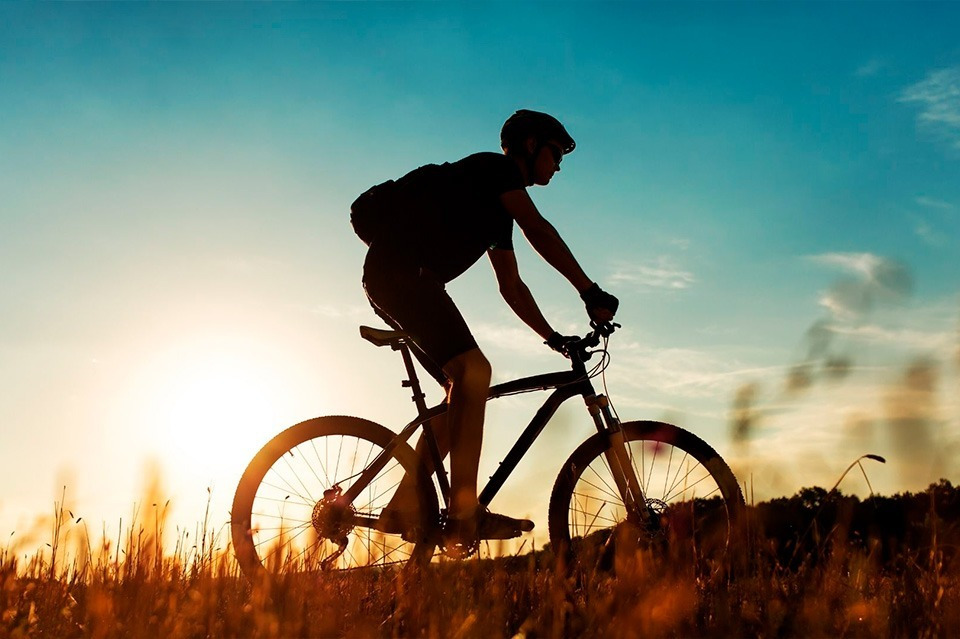 Cyclist enjoying sunset, views of Sea You: Port Saplaya