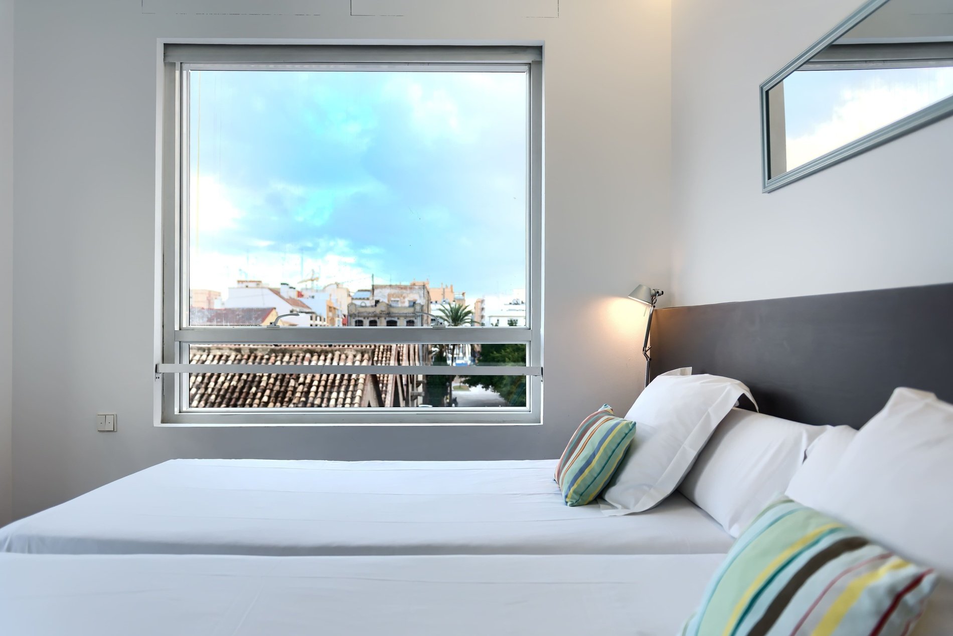 une chambre avec deux lits et une grande fenêtre