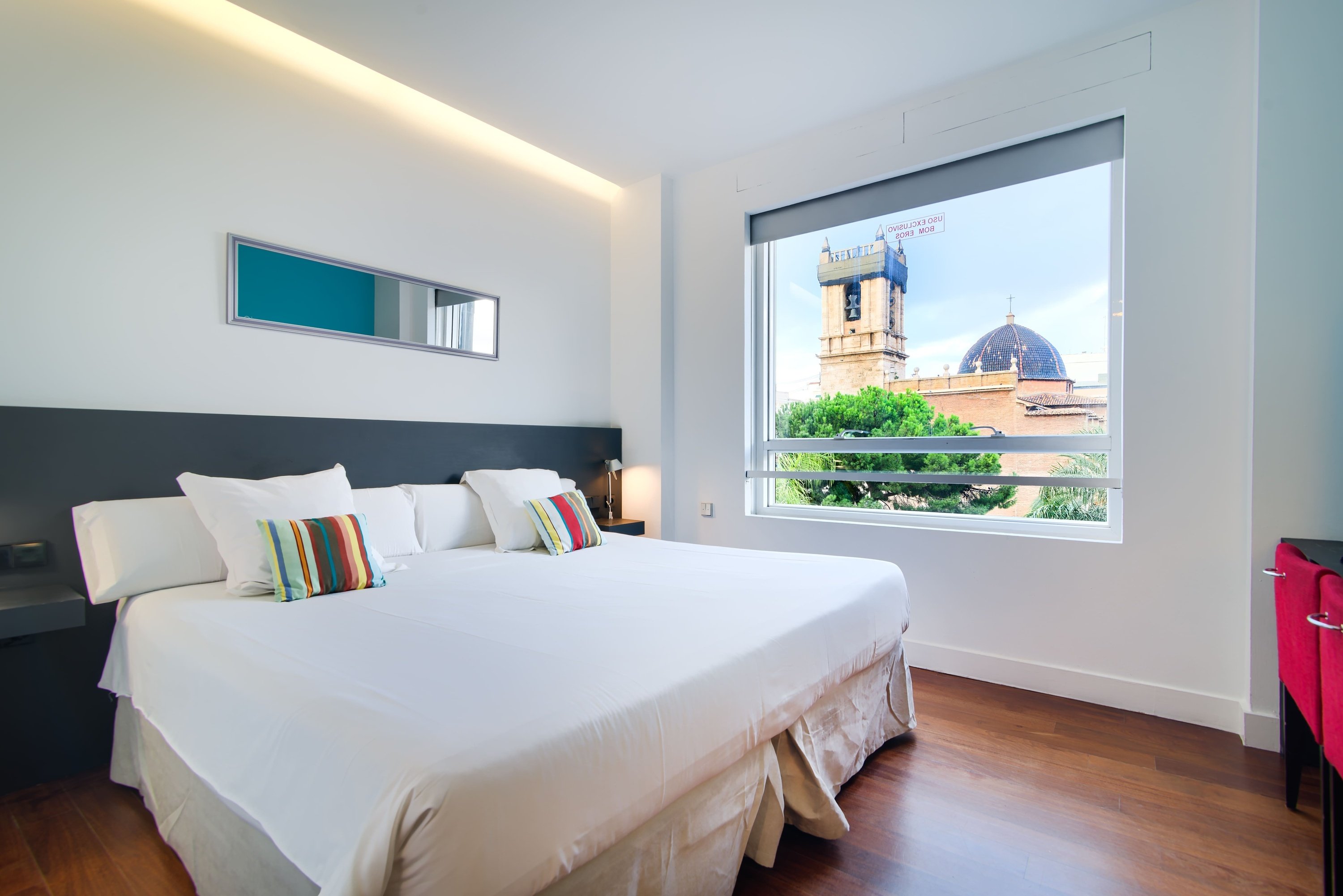 a hotel room with a large bed and a large window