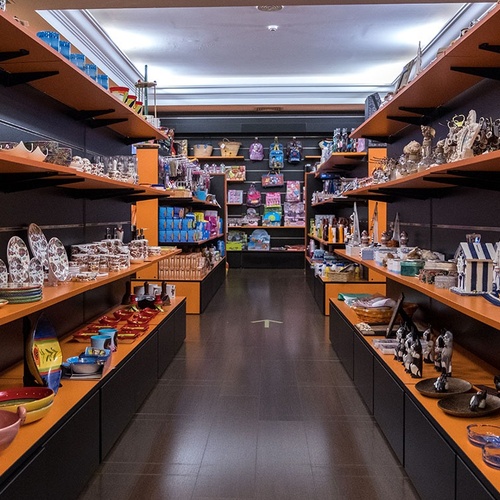 un largo pasillo de una tienda llena de platos y tazas