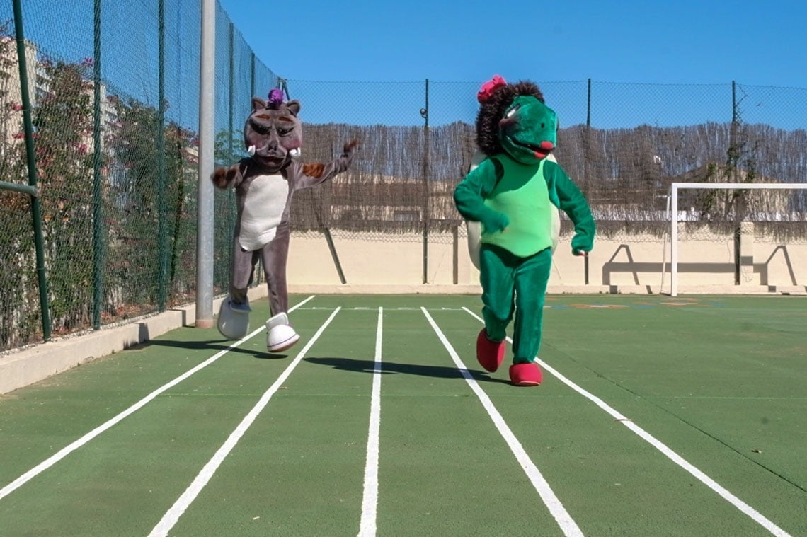un unicornio y un erizo están corriendo en una pista de atletismo
