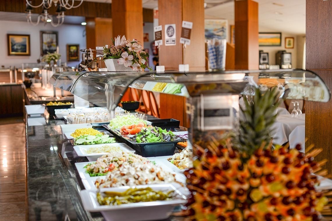 a buffet line with a pineapple in the foreground